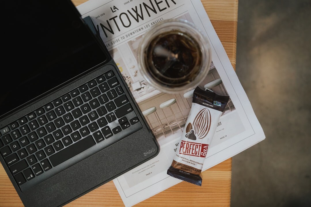 Flat lay of a keyboard, coffee cup and notebook