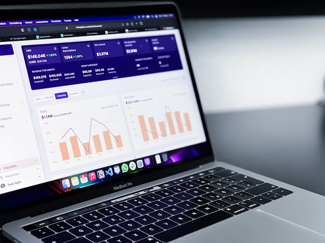 Laptop displaying data and charts on a desk