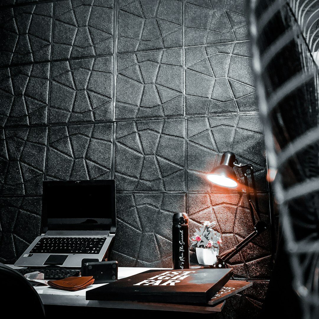 Programmer typing code on a laptop at a desk