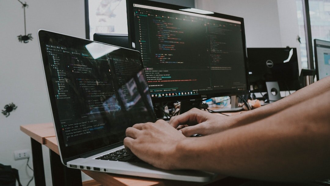 person coding on laptop