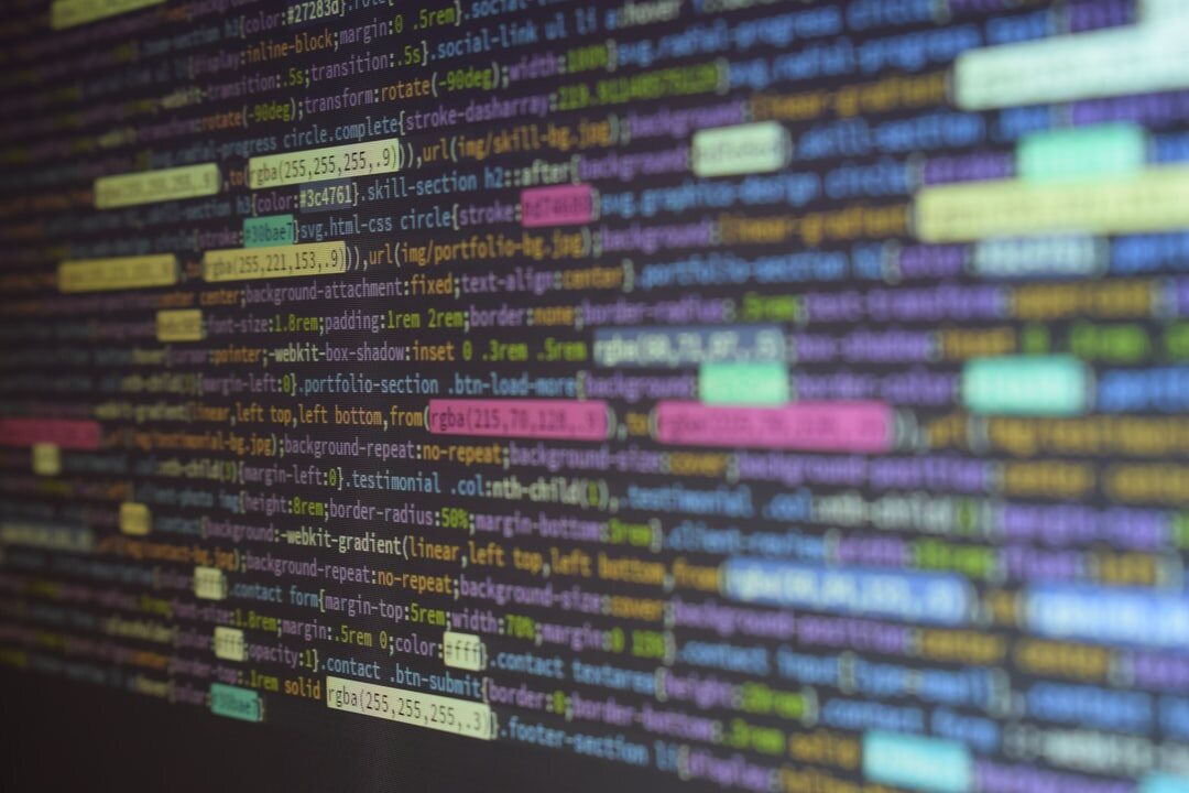 Close-up of colorful source code on a monitor