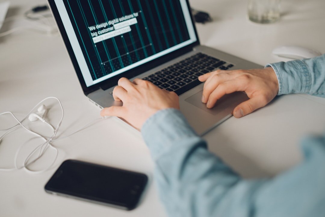 programmer typing code on laptop