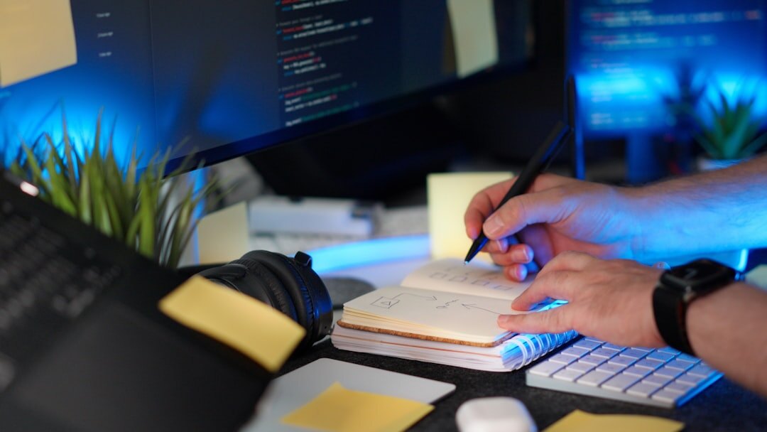 person writing code on notebook