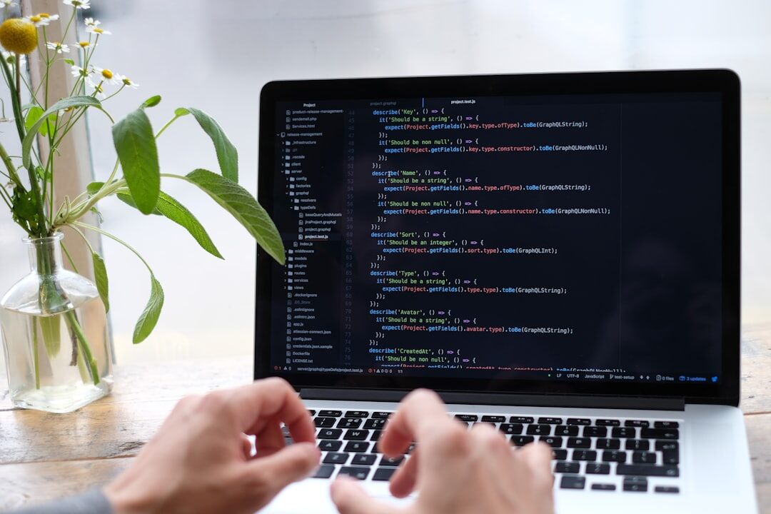 young man coding on laptop