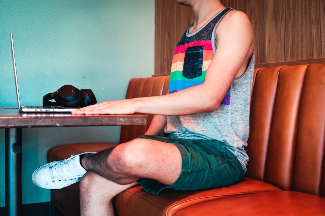 young man coding on laptop