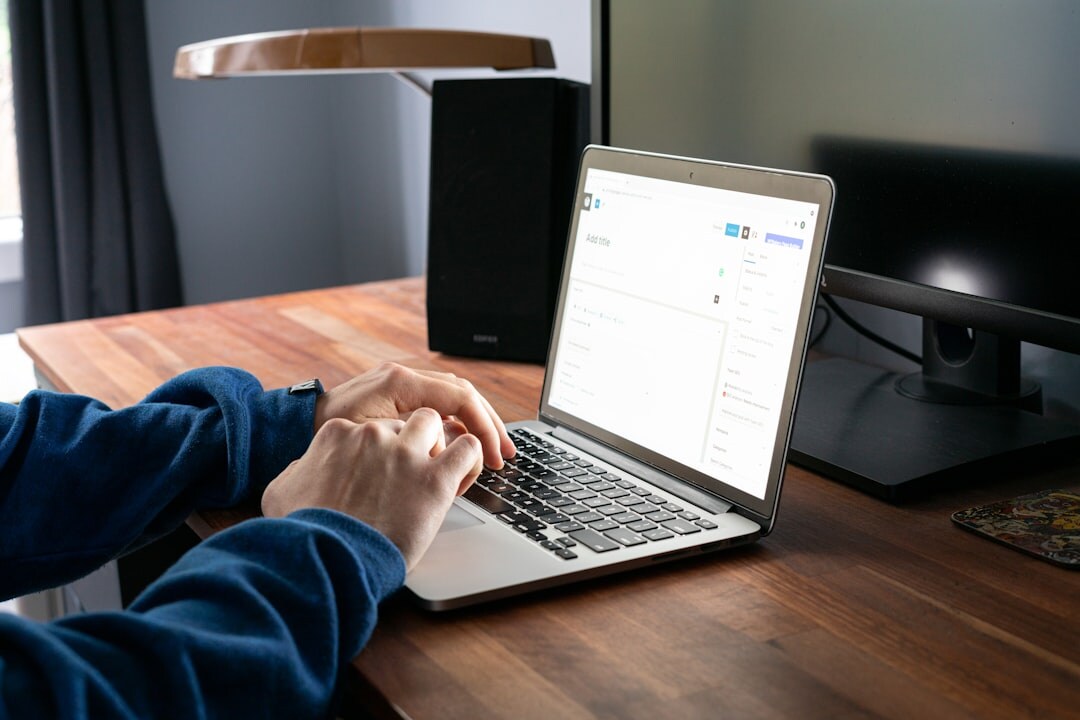 person coding on laptop